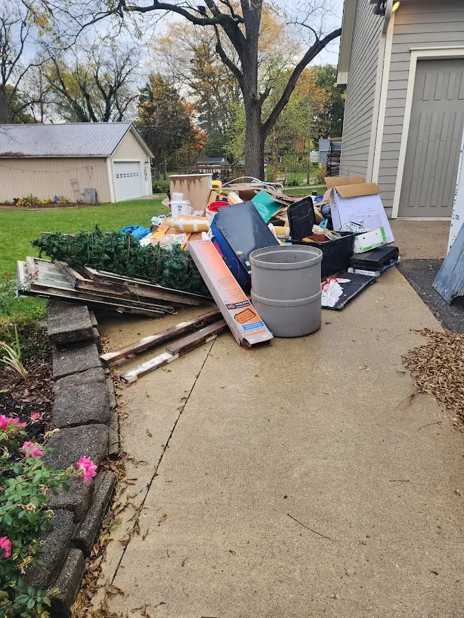 Dumpster being loaded with debris for 3 Yard Dumpster Rental in South Riding